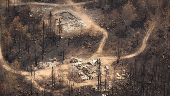 scorched-earth-and-debris-left-in-wake-of-wildfire-at-namaygoosisagagun-first-nation